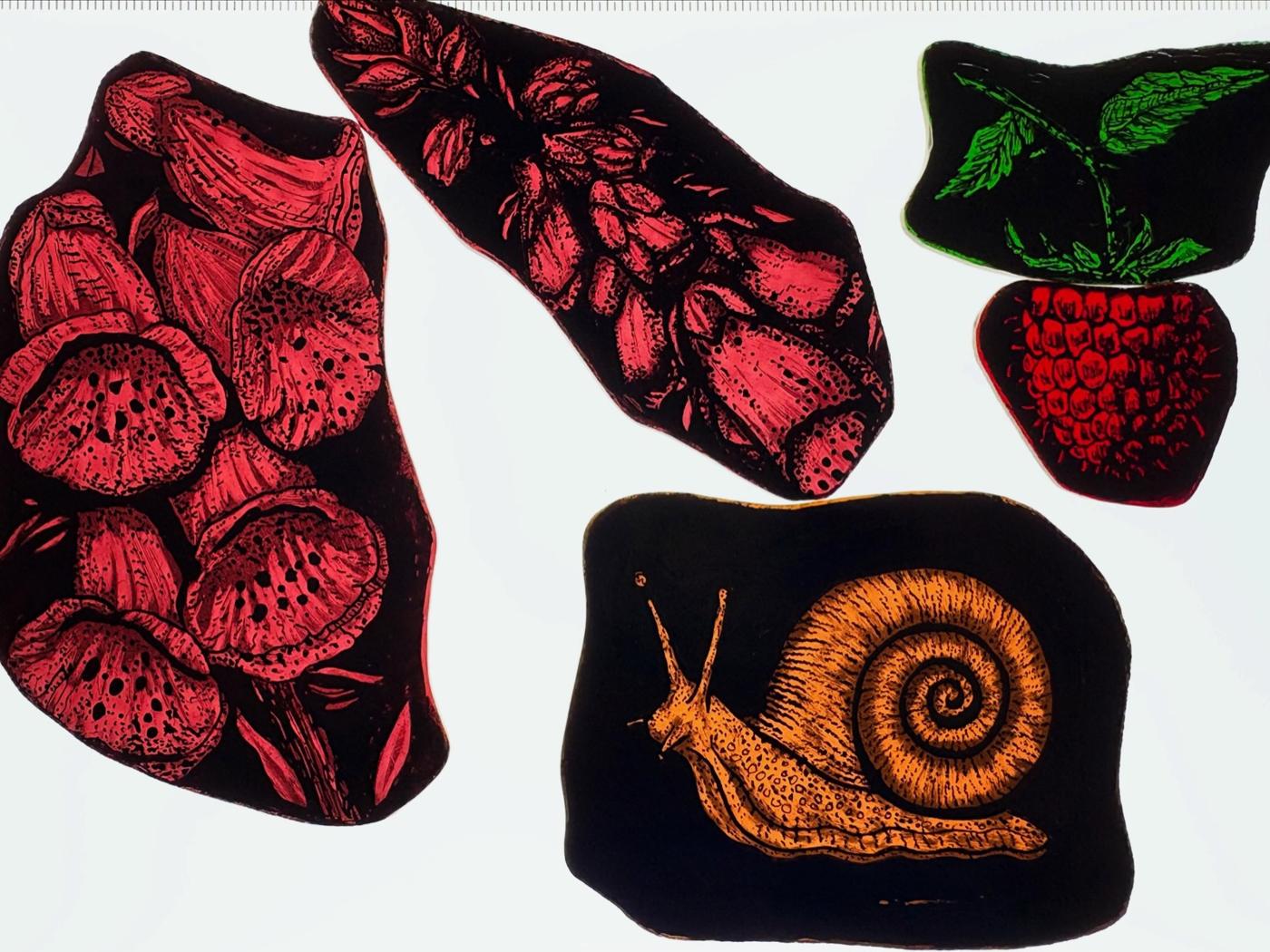 Painted glass pieces of foxglove, leaves and a snail laid out before leading